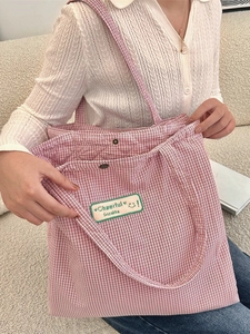 Pink plaid canvas tote bag with Cheerful Sozakka patch shown in a casual home setting
