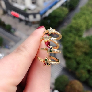 Handheld gold star-shaped open ring with colorful zircon stones in a stylish street setting