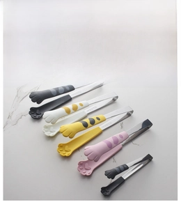 Detail of cat paw silicone food tongs in multiple colors with hanging hole and non-slip grip