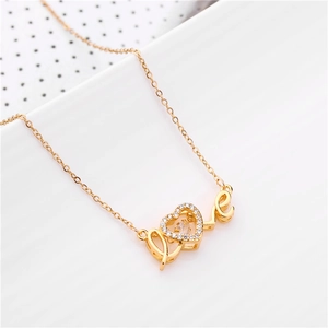 Close-up of golden Love necklace with a floating heart-shaped cubic zirconia pendant