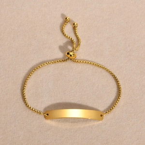 Minimalist adjustable gold stainless steel bracelet with a smooth bar for custom engraving