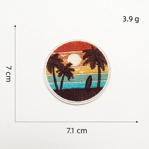 Detail of round beach sunset embroidery patch with palm trees and surfing board design