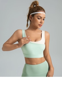 Close-up of mint green high-impact sports bra with wide straps and seamless texture