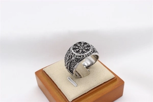 Macro view of vintage Viking Vegvisir compass ring with Norse runes on stainless steel