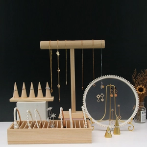 Multifunctional wooden jewelry display set with necklace stands and ring cones on black background