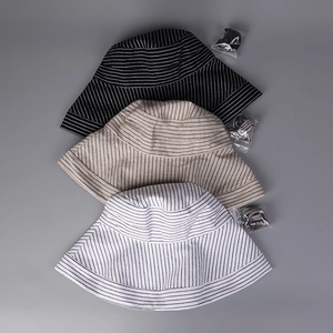 Detailed top view of striped cotton linen sun hats in black, beige and white colors