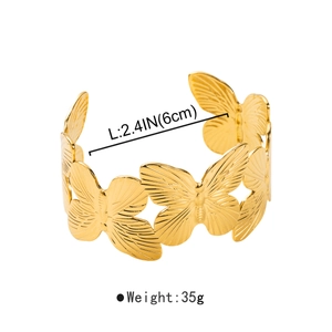 Macro shot of 6cm butterfly cuff bangle in gold finish with 35g weight detail