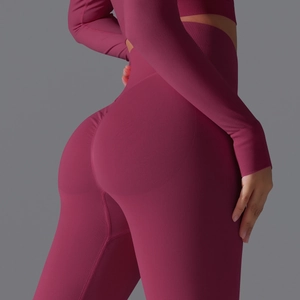 Detail of high waisted seamless yoga pants in magenta with peach lift shaping design