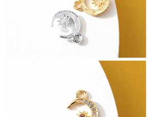 Detailed view of sun and moon charms in gold and silver with sparkling rhinestones