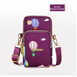 Detail of purple crossbody mobile bag with colorful hot air balloon pattern and gold zippers
