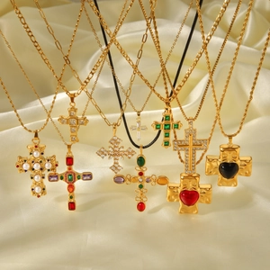 Gold stainless steel cross necklaces with colorful gemstones and pearls on silk fabric