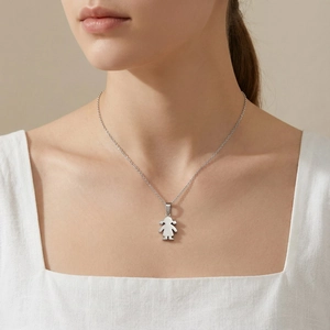 Detailed view of a silver minimalist girl pendant necklace worn by a model