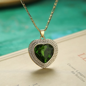 Luxurious green heart crystal necklace with double zircon halo on a gold Figaro chain