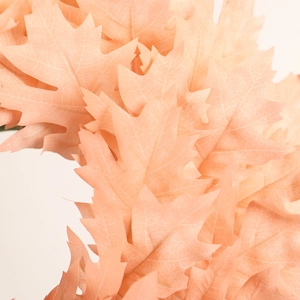 Pink artificial Christmas wreath foliage with detailed fabric texture for home decoration