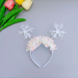 Christmas snowflake headband with iridescent fringe and white decor on grey background
