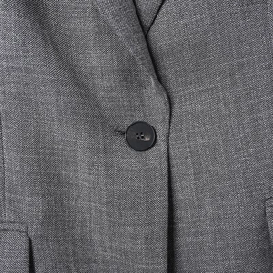 Macro shot of gray twill fabric texture and matte black button on the stylish blazer