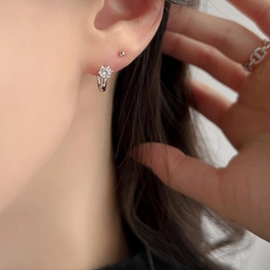 Close-up of minimalist 925 sterling silver hoop earrings with cubic zirconia on model
