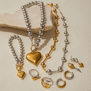Mixed gold and silver stainless steel jewelry set with heart pendants and rings