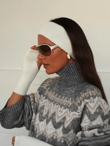 Detailed texture of white ribbed knit headband and matching fingerless gloves
