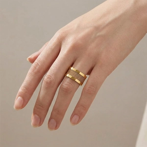 Fashionable gold wide band ring with woven mesh texture for women on a model's hand