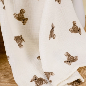 Detail of soft double-layer cotton nursing cover featuring cute brown teddy bear print