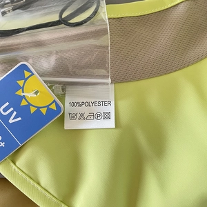 Detail of light green UPF 50+ sun hat showing 100% polyester label and UV protection tag