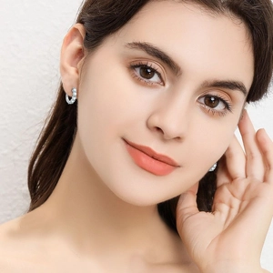 Elegant S925 sterling silver hoop earrings with moissanite stones on a female model