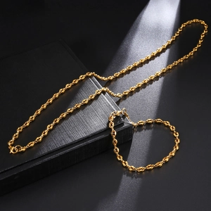 Close-up of golden coffee bean link necklace and bracelet set with lobster clasp