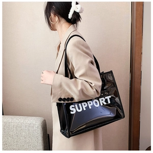 Modern transparent PVC tote bag with white SUPPORT text shown on a model's shoulder