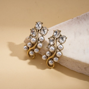 Detailed macro view of vintage gold finish earrings with pearls and crystals