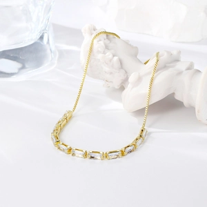 Detailed macro view of an adjustable gold-plated bracelet with radiant zircon stones