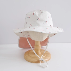 Detailed view of quick-dry sun hat with cherry print and long neck protection flap