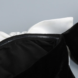 Close-up of black velvet off-shoulder dress with white satin trim and anti-slip silicone