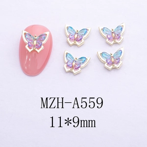 Macro view of 11x9mm hollow gold-edged butterfly nail charms with iridescent wings