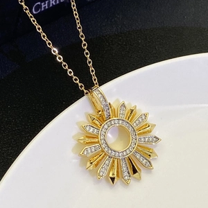 Close-up of a gold-plated sunflower pendant necklace with sparkling white zircons