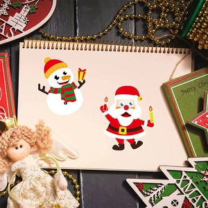 Christmas DIY stickers with Santa and snowman on a notebook with holiday decor