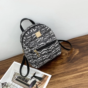 Fashionable mini backpack with black and white woven texture and golden zippers