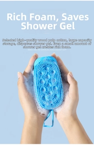 Detailed close-up of blue silicone bath brush with fine bristles creating rich foam lather