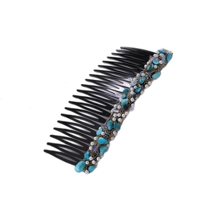 Detail of a black hair comb with turquoise beads and pearl accents for vintage hairstyling