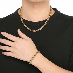 Hip hop style gold twist rope chain necklace and bracelet set worn by a male model