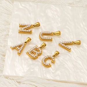Handmade 18k gold plated stainless steel initial pendants with white pearls on marble