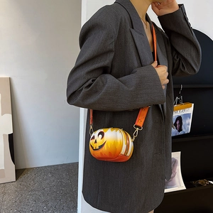 Detail view of pumpkin crossbody bag with gradient orange finish and metal zipper