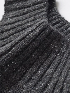 Dettaglio ravvicinato della maglia a coste grigio scuro con trama morbida ed effetto mélange