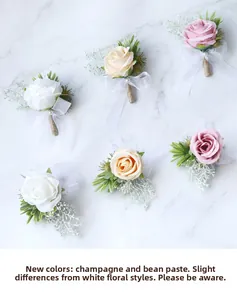 Detail of silk rose boutonniere with pearls, champagne color and lace ribbon on marble