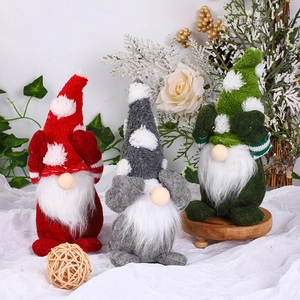 Three Christmas gnomes with snowflake hats in red, gray and green for holiday decor