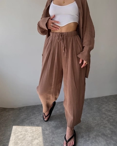 Detail of brown linen casual set with long sleeve shirt and belted high waist pants