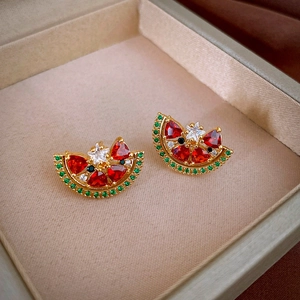 Macro shot of gold-plated watermelon studs with red and green cubic zirconia stones