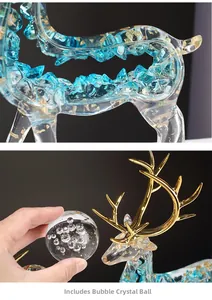 Detail of blue resin elk with gold foil and a complementary bubble crystal ball