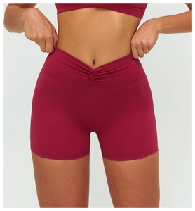 Close-up of high-waisted yoga shorts featuring V-shaped cross pleated waistband design