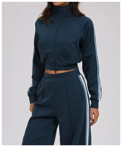 Detail of navy track jacket with white side stripes and stand collar for outdoor sports